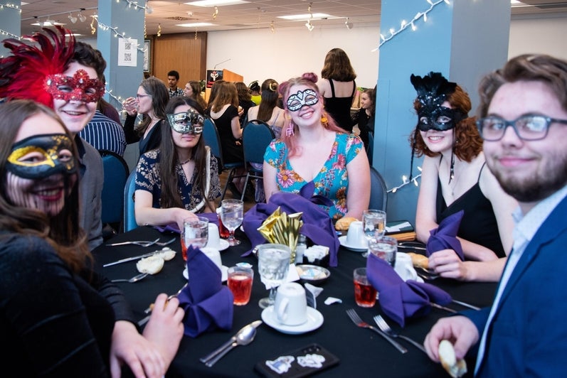studnets wearing masks gathered around a round table