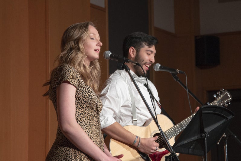 Two students sing during a talent show in the great hall