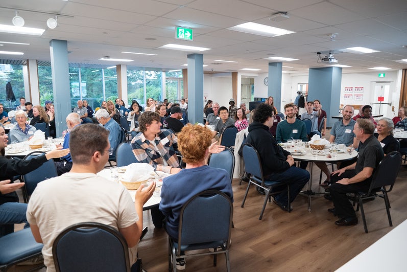 The grebel alumni and student attendees applaud Peter Hart