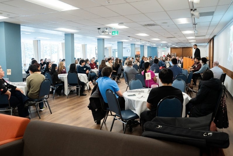 an event with guests sitting at round tables in the grebel dining room
