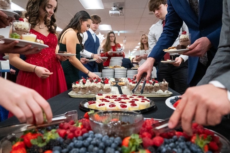students choose from several small deserts at a banquet event