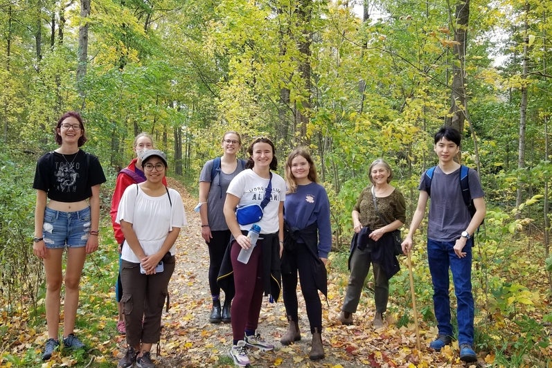 students standing in a group in a forest 