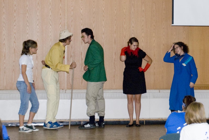 students on the great hall stage perform a skit (2000s)