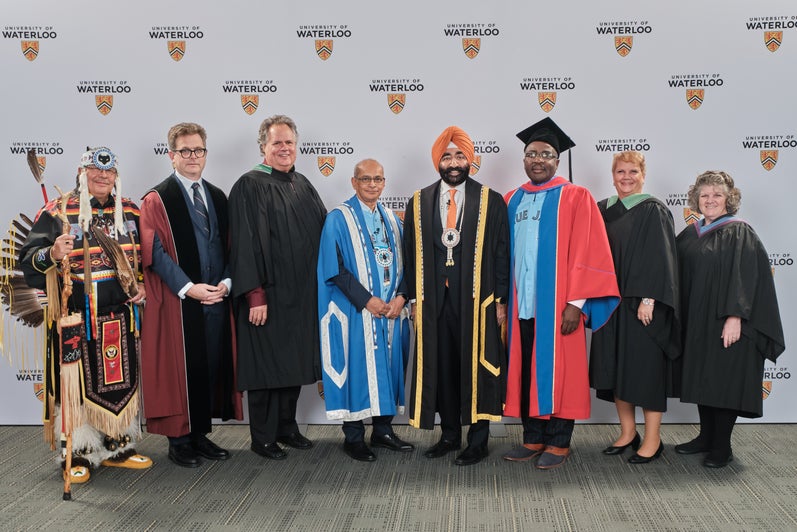 8 people in academic regalia