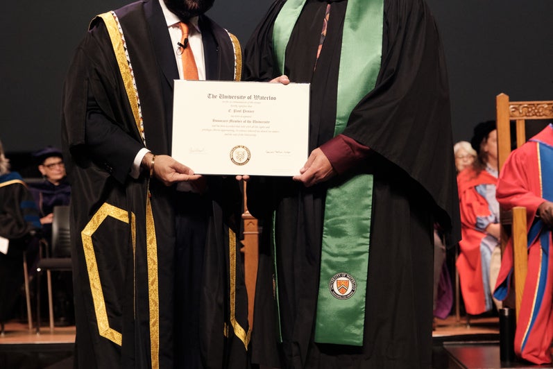 Paul being presented with his certificate on stage