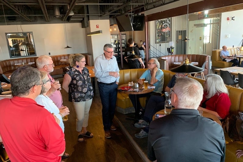 alumni standing together in a restaurant