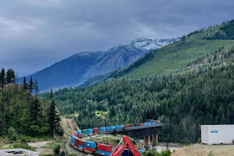 A scenic view of Lytton, BC, with mountains overlooking construction
