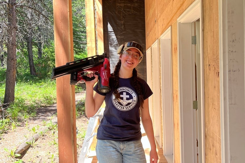 Mona Bailey on an MDS work site with a drill