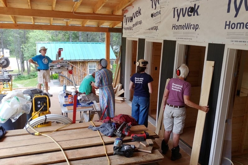 Mona Bailey and other volunteers working on a construction site