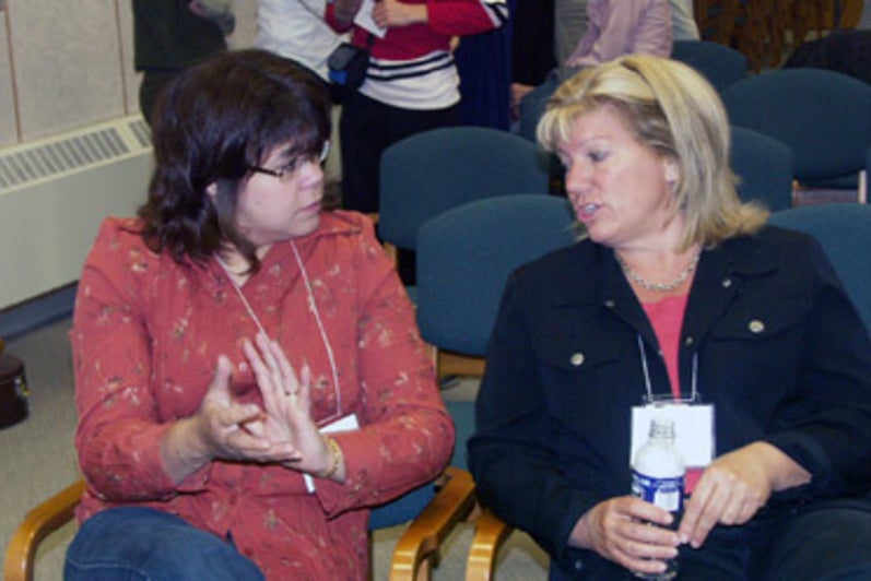 Two women talking in the auditorium
