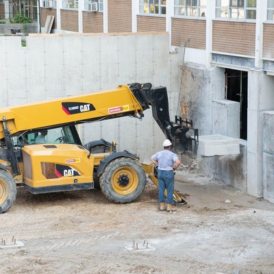 Concrete is removed from foundation by heavy machinery