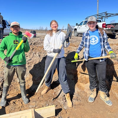 3 students holding tools