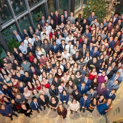 Group photo in the atrium, with students, staff, faculty.