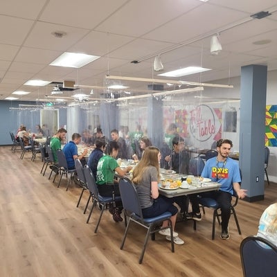 Students enjoy eating together in the new dining room, set up with plastic barriers for COVID prevention 
