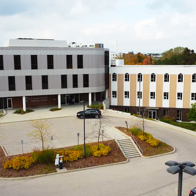 A birds eye view of the Grebel front entrance, and parking lot