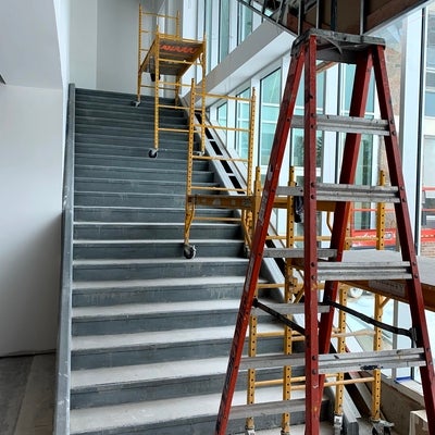 new stairs towards the chapel, with windows and construction ladders