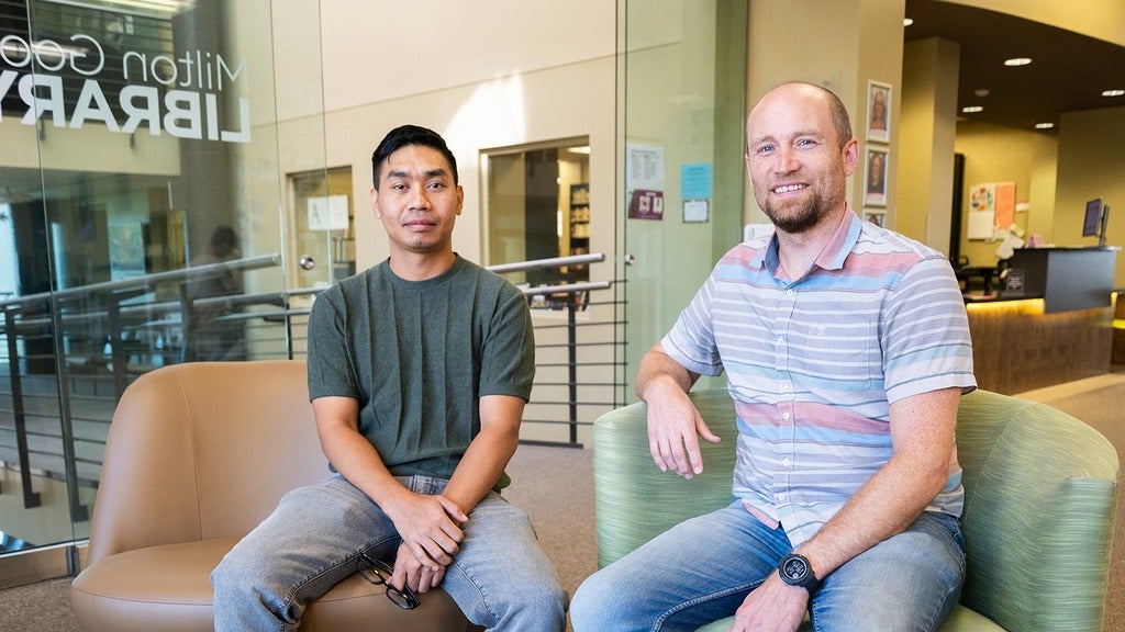 Two Master of Theological Studies students sitting in the library