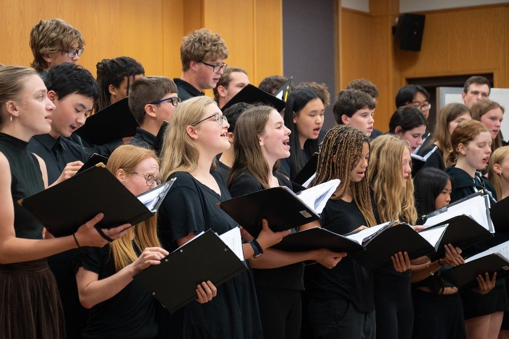 choir group singing holding books