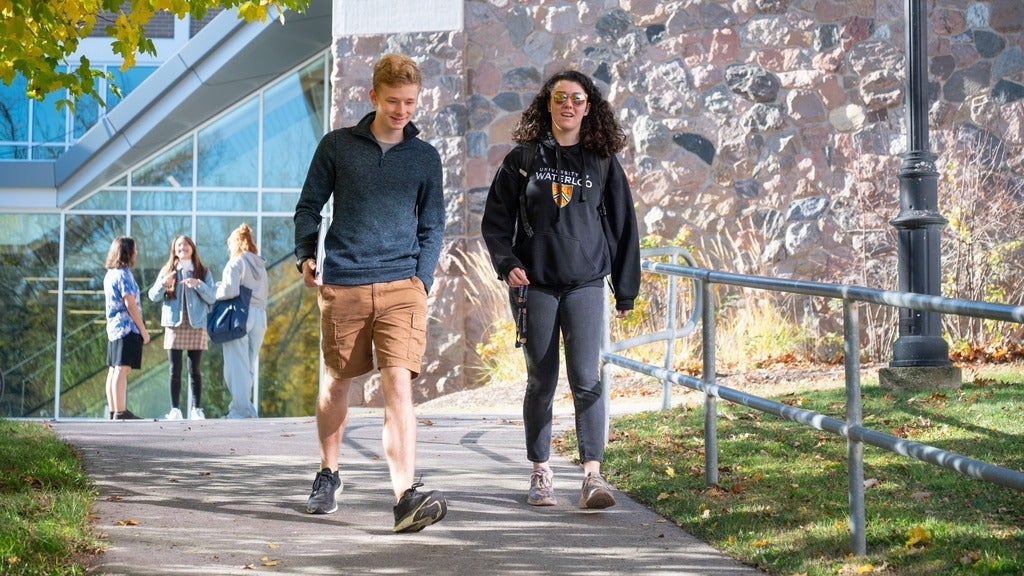 Students walking down outdoor path at Grebel