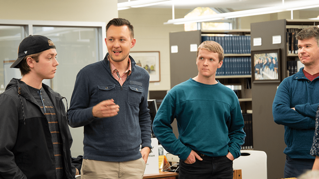 david neufeld teaching to a small group in library 