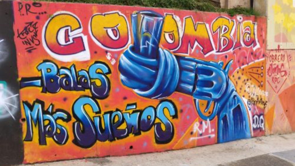 Grafitti that says Colombia, with a gun nozzel tied in a knot