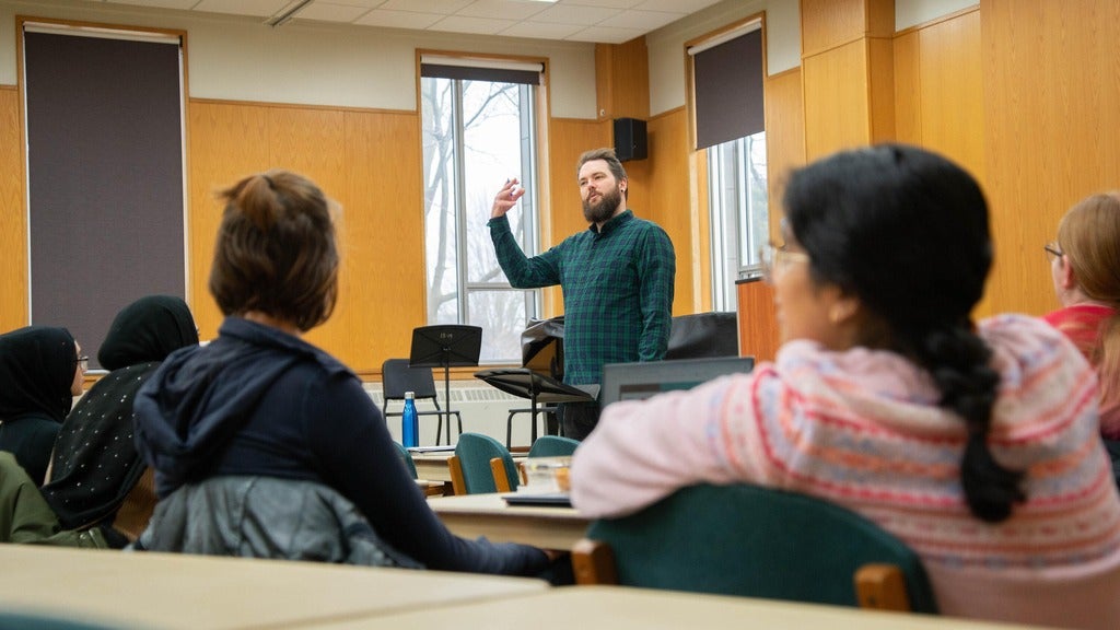 Eric standing in front of a class lecturing 
