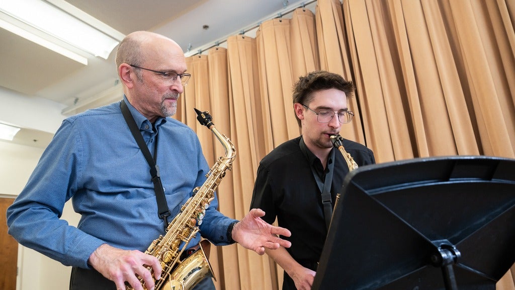 Ernie Kalwa teaching saxophone to a student
