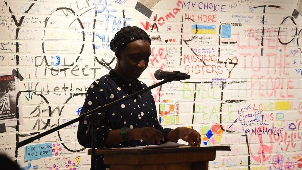 Faraja standing at a podium 