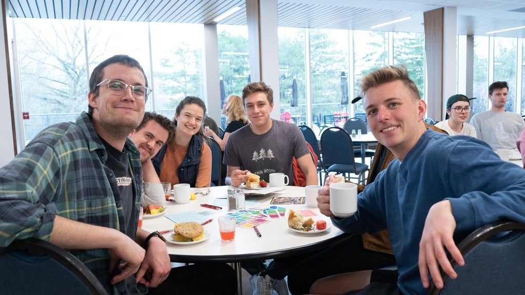 students gathered around a round table