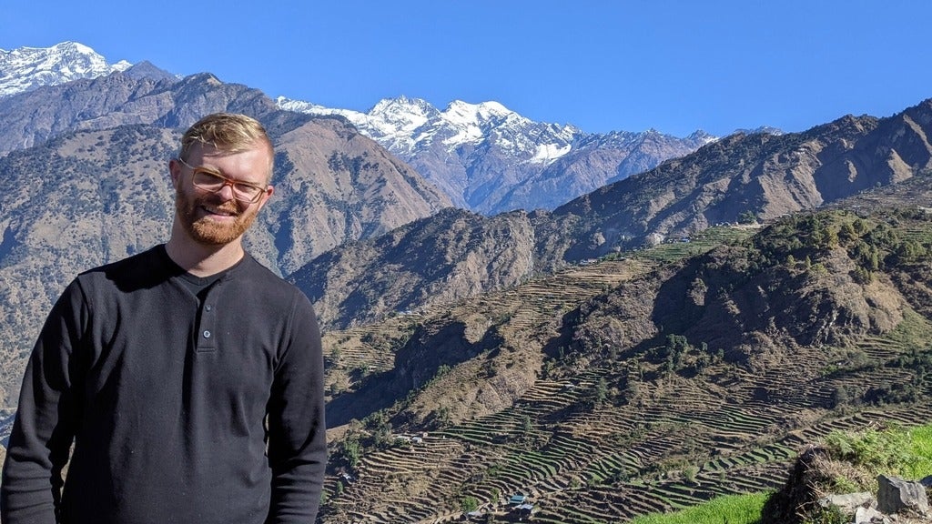 luke jantzi standing in front of a mountain range 