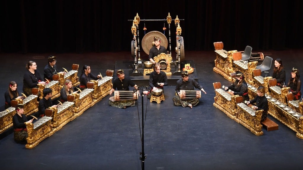 students sitting at Gamelan instruments 