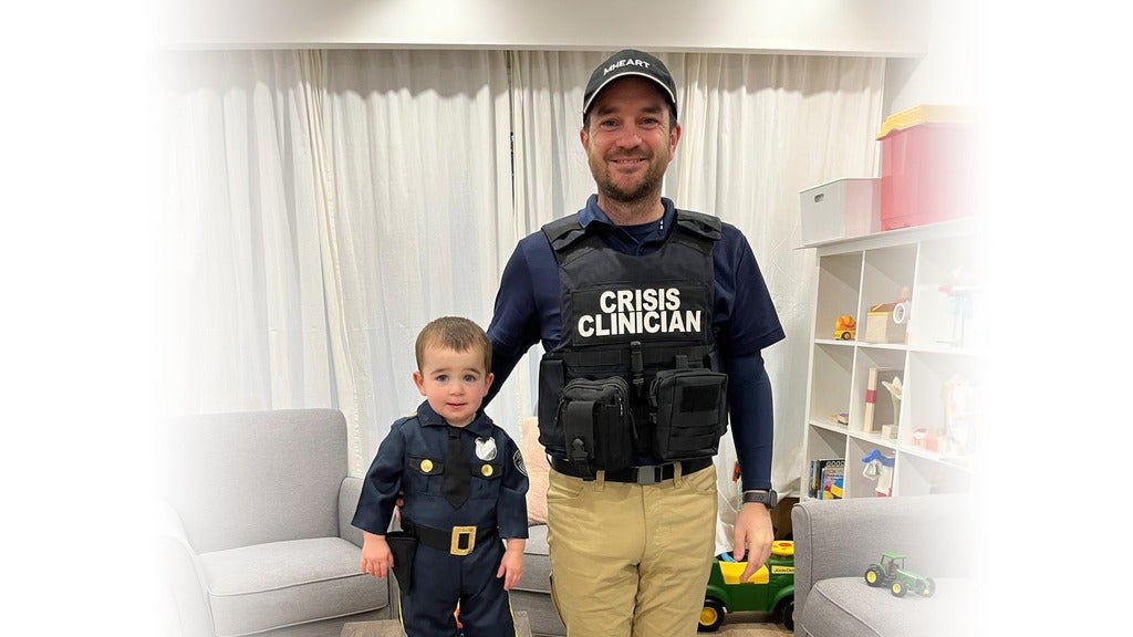 Neil and his son Wray in police uniforms.