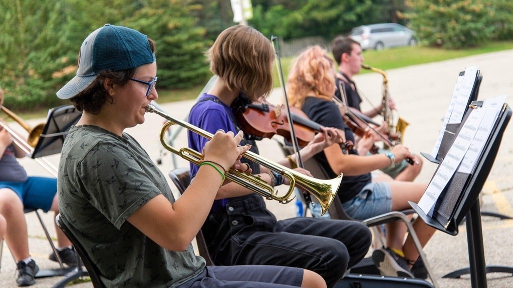 OMMC campers playing instruments outside 