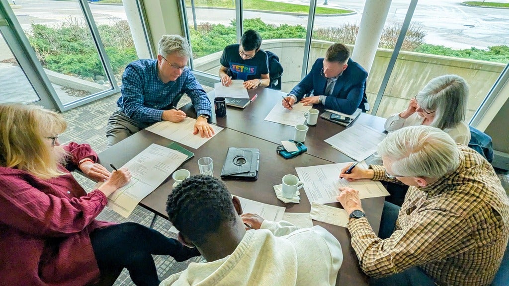 Faculty, staff, and board members brainstorming