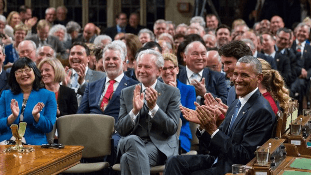 Harder sitting in crowd beside Barack Obama and former Prime Minster Justin Trudeau