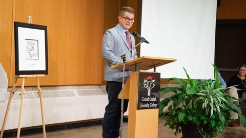 marcus shantz speaking at a podium 