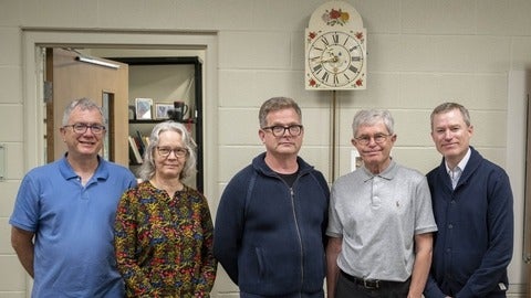 Troy Osborne, Laureen Harder-Gissing, Marcus Shantz, Bert Friesen, and Kenneth Friesen, with the Mennonite wall clock