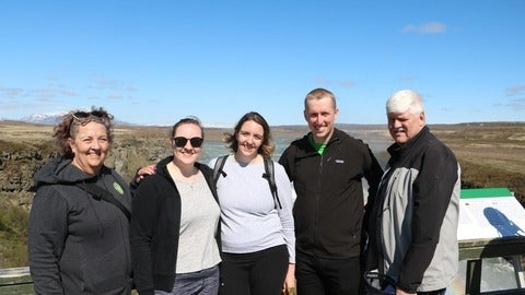 balzer family posing in front of landscape