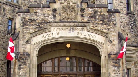 An ornate stone entrance to Confederation Building, in ottawa. 