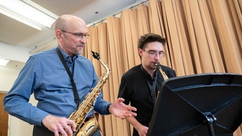 Ernie Kalwa teaching saxophone to a student
