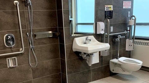 bathroom with toilet, sink and a shower 