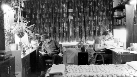 two students working at desks in thier residence rooms
