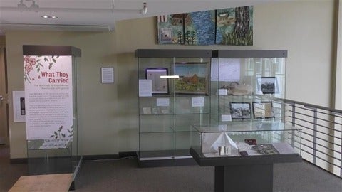 Display cases with objects in them and "What They Carried Exhibit" sign