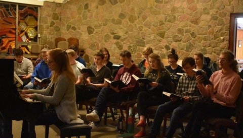 Students singing in chapel