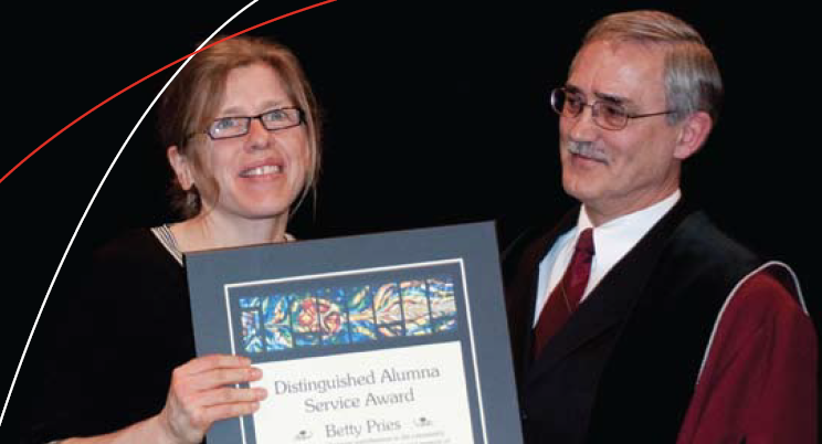 Betty Pries receiving the Distinguished Alumna Service Award from Henry Paetkau.