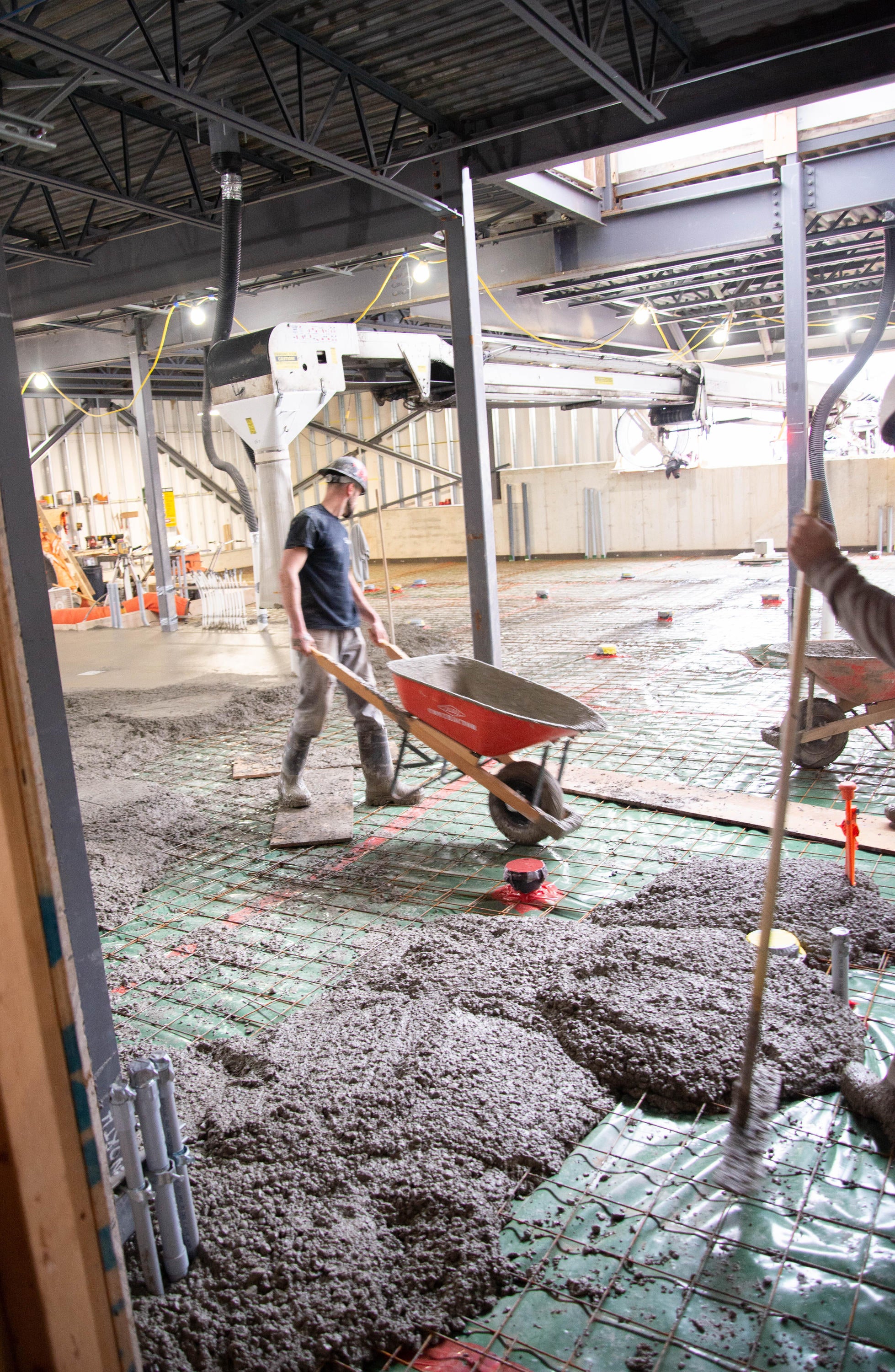 Concrete being poured from a wheel barrow in the new kitchen space