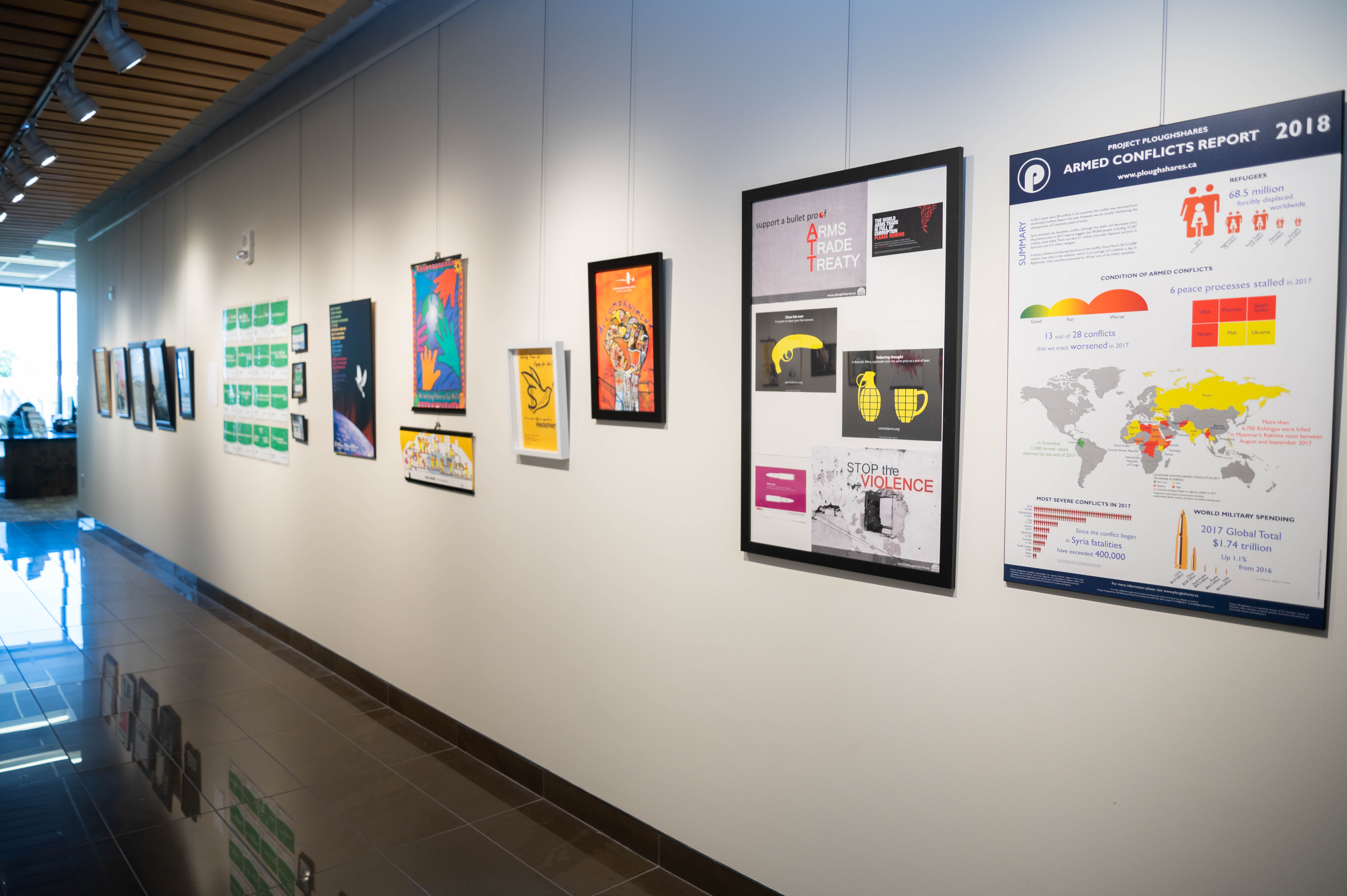 A wall of the Grebel Gallery, with serveral posters depicting peace movements.