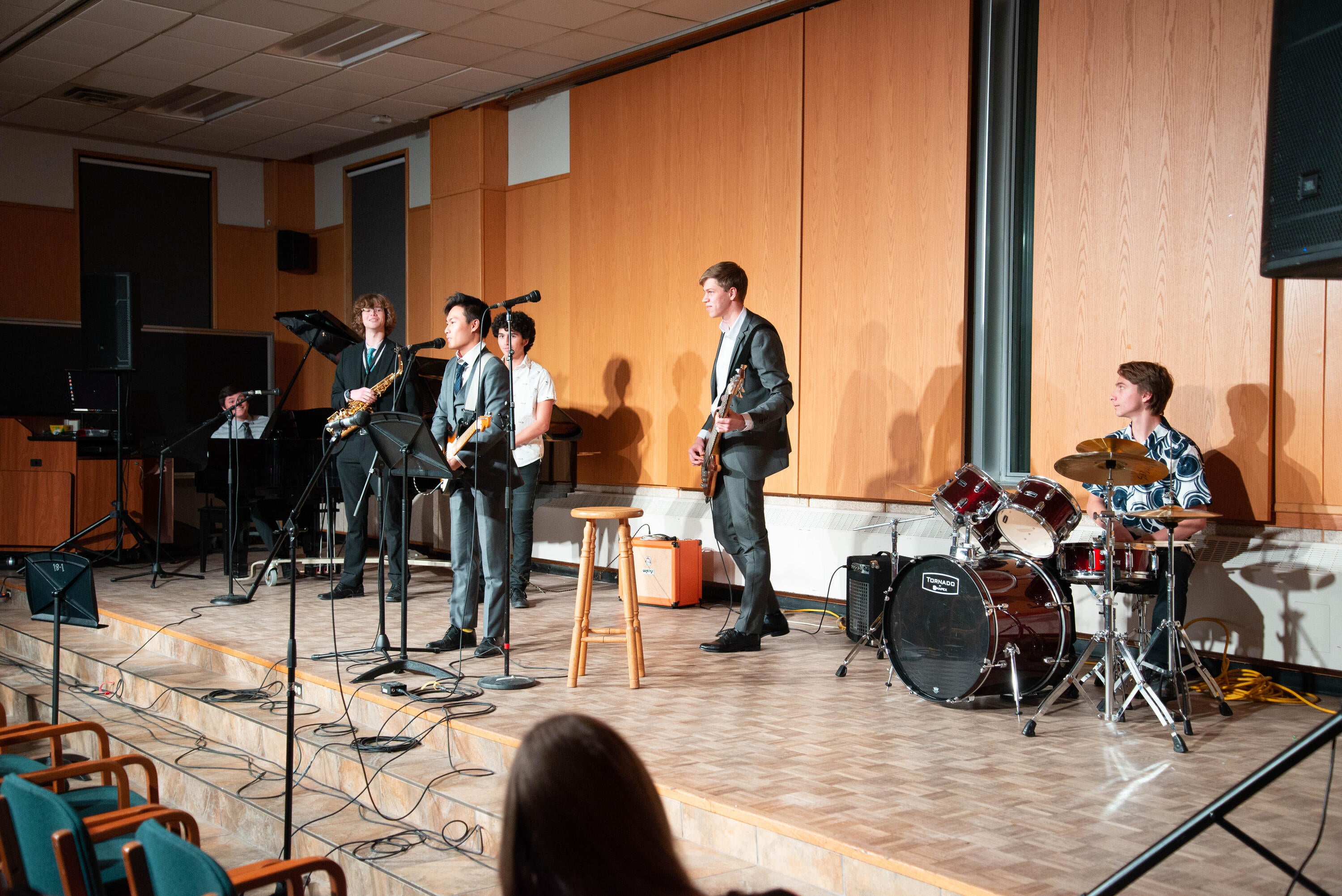 Matthew plays with a band during a grebel talent show