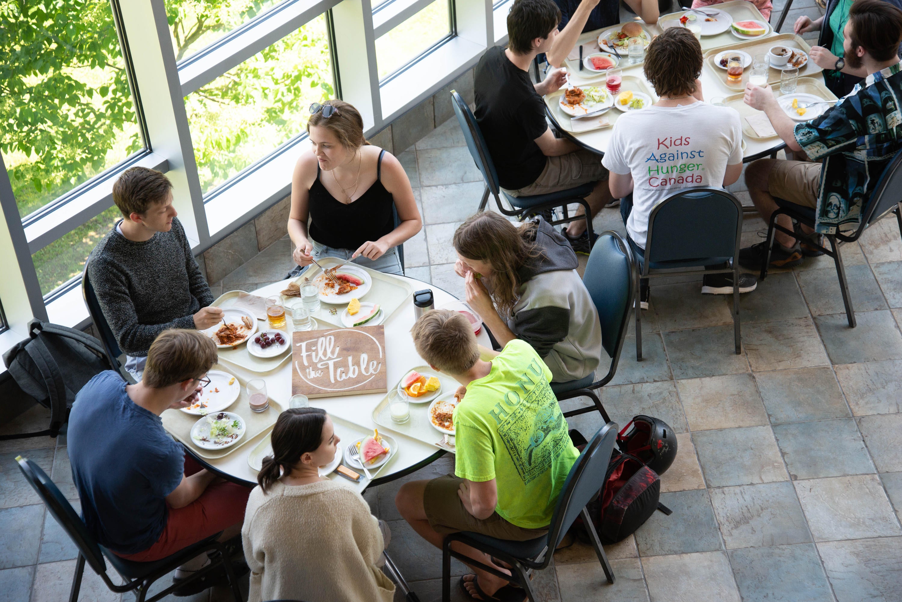 Summer students eat in the upper atrium during construction