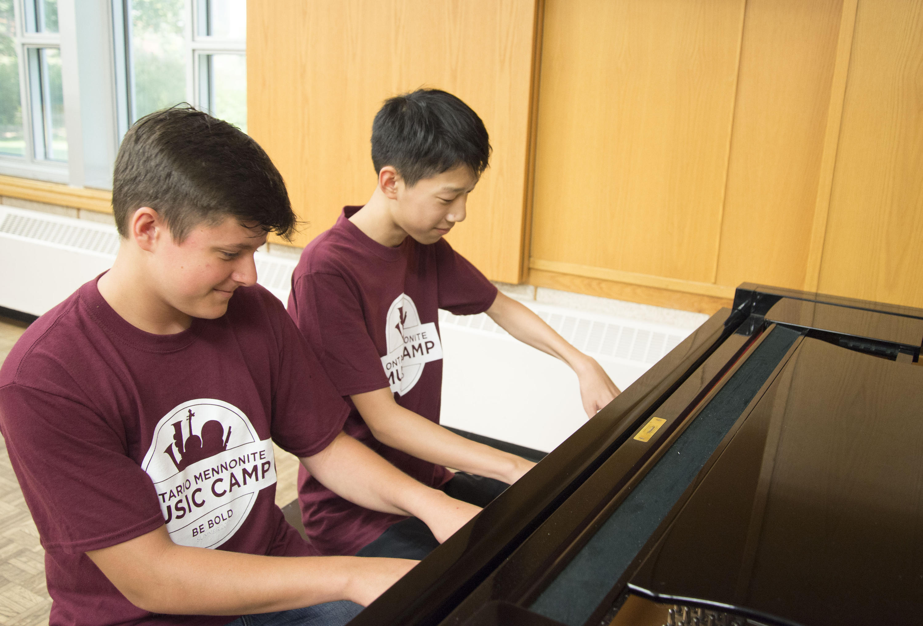Two students playing piano